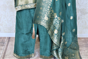 Shop dark green embroidered silk palazzo suit online in USA with dupatta. Elevate your ethnic style on weddings and festive occasions with stunning designer Anarkali suits, sharara suits, palazzo suits, salwar suits from Pure Elegance Indian fashion boutique in USA.-palazzo