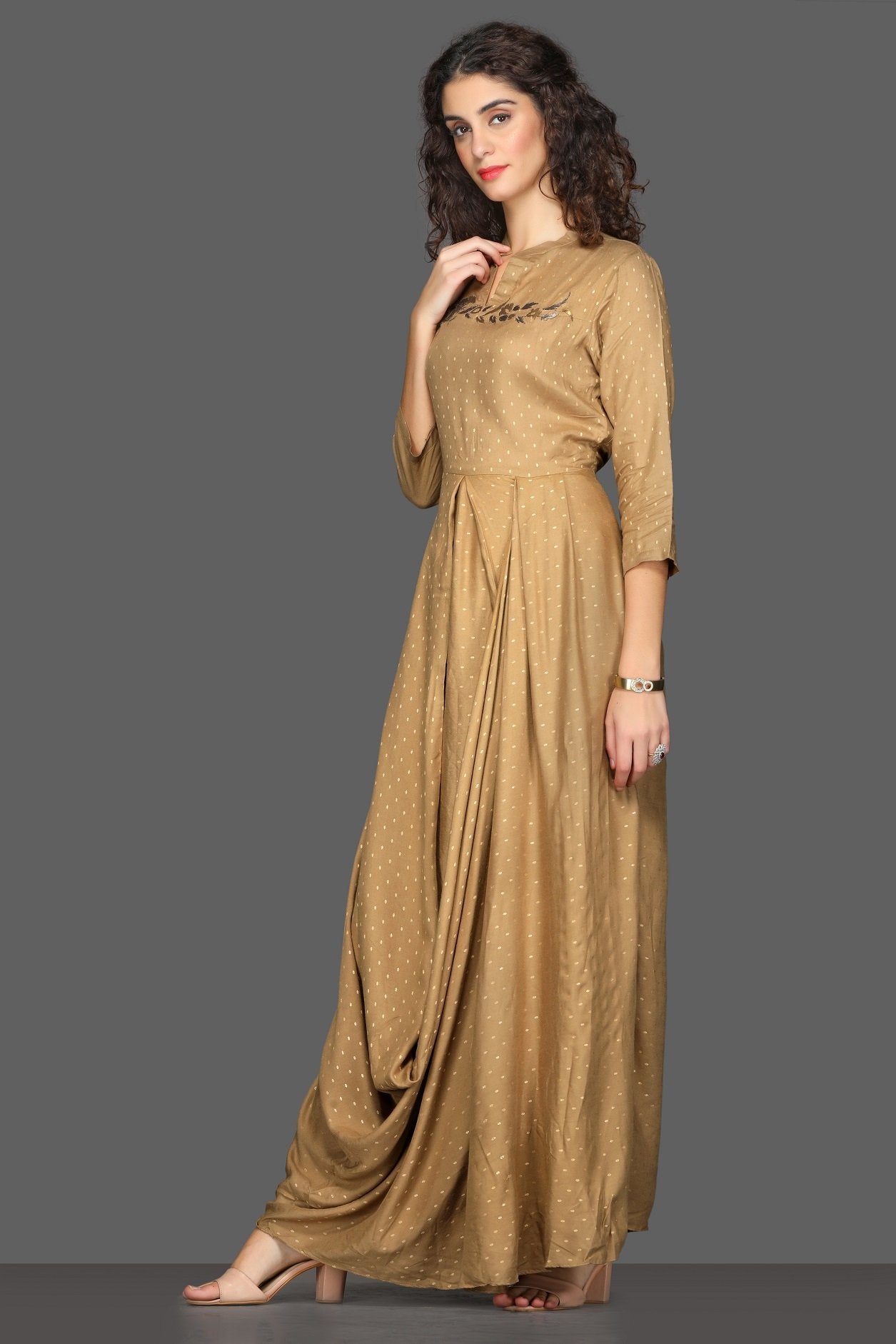Buy elegant beige draped maxi dress online in USA. Dazzle on weddings and special occasions with exquisite Indian designer dresses, sharara suits, Anarkali suits from Pure Elegance Indian fashion store in USA.-side