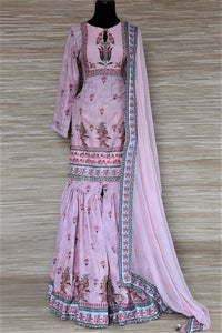 Buy stunning powder pink floral embroidered silk sharara suit online in USA with dupatta. Choose from a splendid variety of sharara suits, Anarkali suits, designer lehenga for weddings and festive occasions from Pure Elegance Indian clothing store in USA.-full view