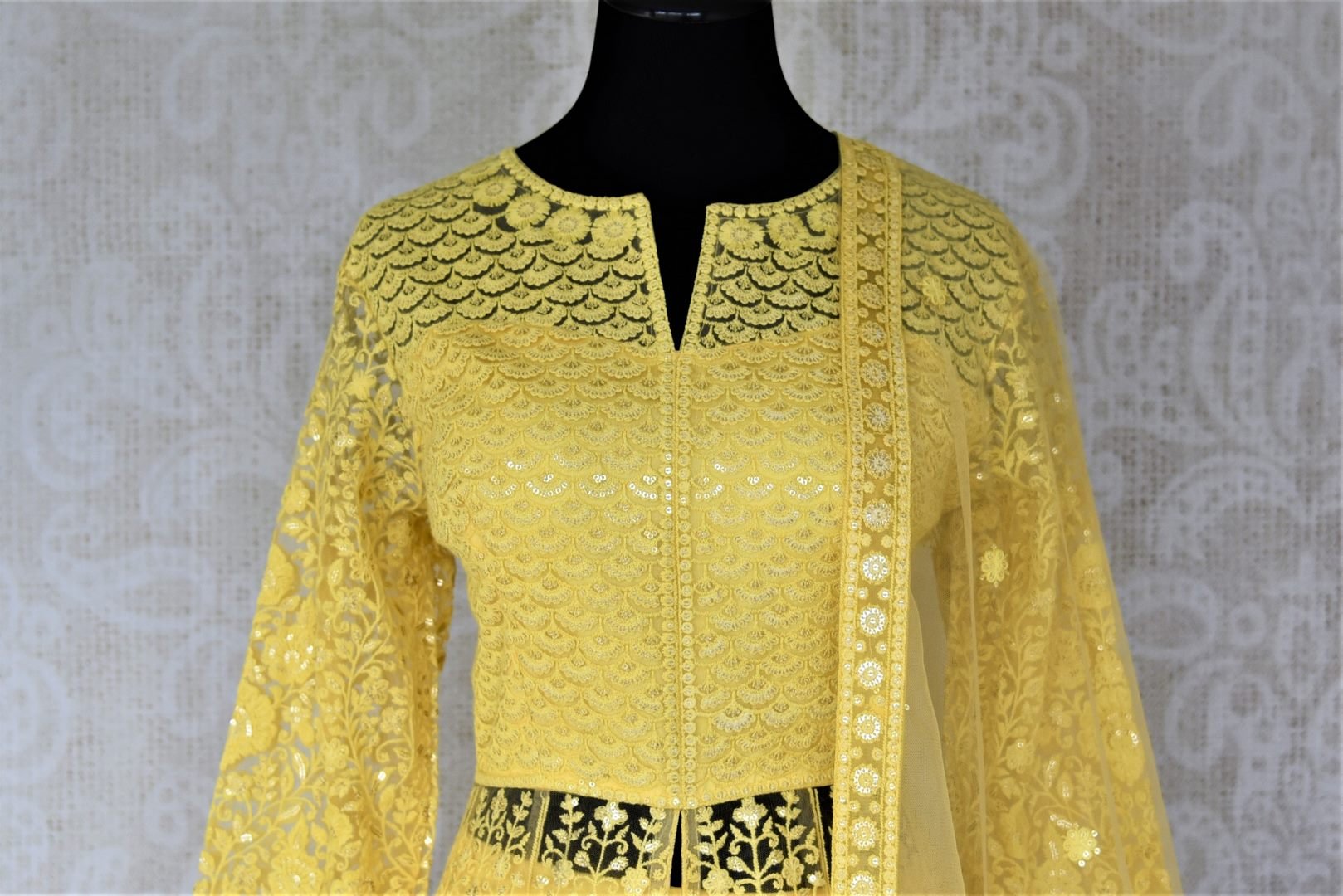Shop gorgeous yellow embroidered net Anarkali with dupatta online in USA. Flaunt your sartorial choices on special occasions with beautiful designer dresses, Anarkali suits, traditional salwar suits, Indian lehengas from Pure Elegance Indian fashion boutique in USA. -front