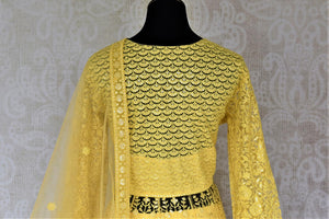 Shop gorgeous yellow embroidered net Anarkali with dupatta online in USA. Flaunt your sartorial choices on special occasions with beautiful designer dresses, Anarkali suits, traditional salwar suits, Indian lehengas from Pure Elegance Indian fashion boutique in USA. -back
