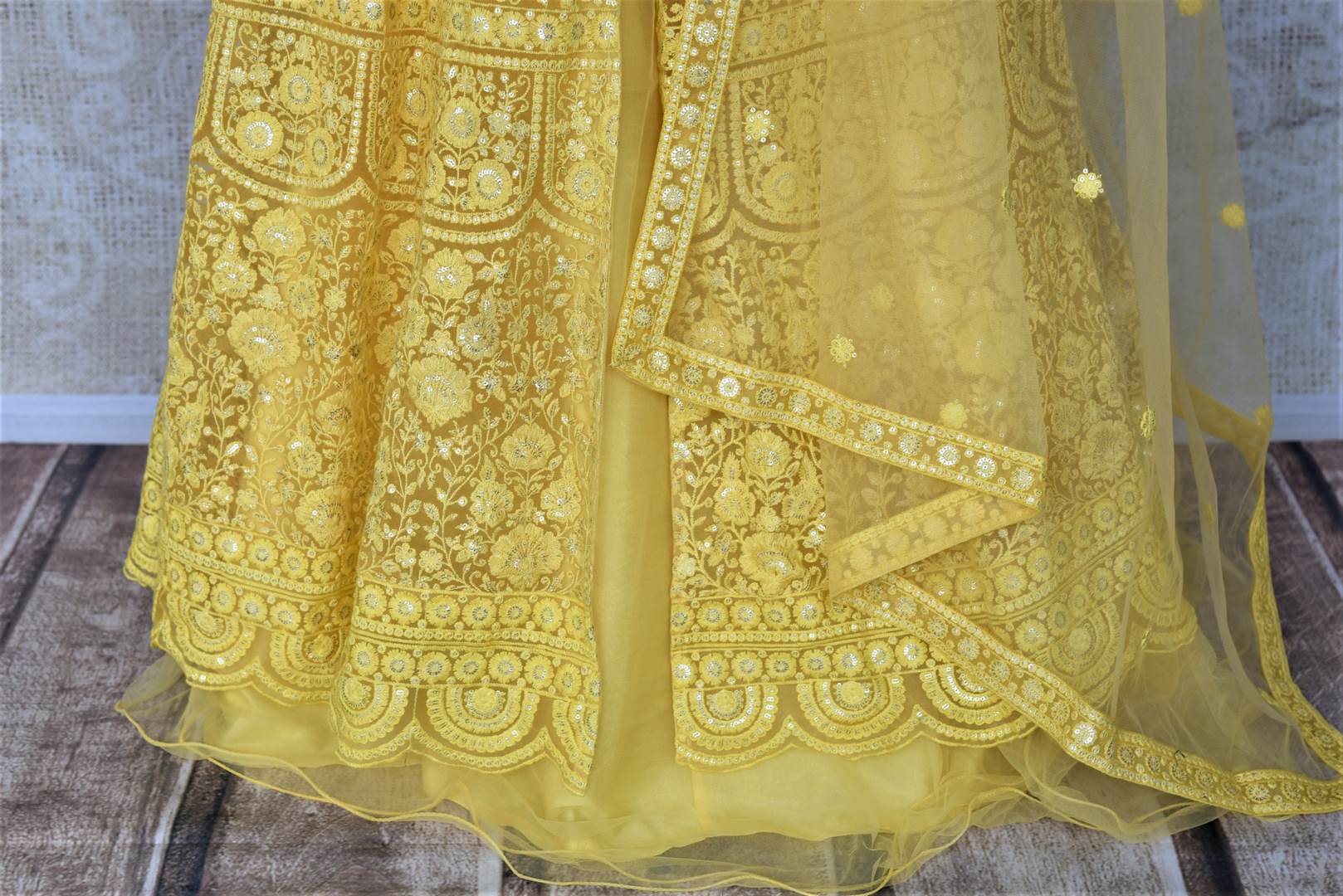 Shop gorgeous yellow embroidered net Anarkali with dupatta online in USA. Flaunt your sartorial choices on special occasions with beautiful designer dresses, Anarkali suits, traditional salwar suits, Indian lehengas from Pure Elegance Indian fashion boutique in USA. -bottom