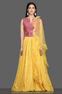 Buy gorgeous pink and yellow mirror work lehenga online in USA with ruffle dupatta. Flaunt your sartorial choices on special occasions with beautiful designer gowns, Anarkali suits, traditional salwar suits, Indian lehengas from Pure Elegance Indian fashion boutique in USA. -full view