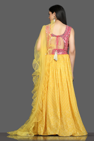 Buy gorgeous pink and yellow mirror work lehenga online in USA with ruffle dupatta. Flaunt your sartorial choices on special occasions with beautiful designer gowns, Anarkali suits, traditional salwar suits, Indian lehengas from Pure Elegance Indian fashion boutique in USA. -back