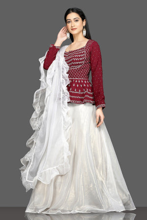 Buy stunning wine and white embroidered lehenga online in USA with white ruffle dupatta. Flaunt your sartorial choices on special occasions with beautiful designer gowns, Anarkali suits, traditional salwar suits, Indian lehengas from Pure Elegance Indian fashion boutique in USA. -left