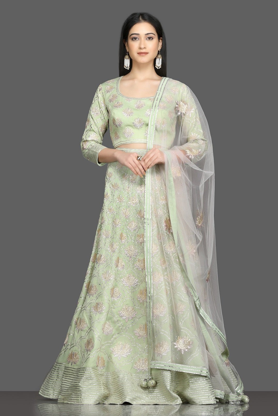 Shop pista green embroidered designer lehenga online in USA with net dupatta. Flaunt your sartorial choices on special occasions with beautiful designer gowns, Anarkali suits, traditional salwar suits, Indian lehengas from Pure Elegance Indian fashion boutique in USA. -full view