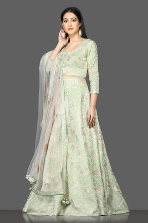 Shop pista green embroidered designer lehenga online in USA with net dupatta. Flaunt your sartorial choices on special occasions with beautiful designer gowns, Anarkali suits, traditional salwar suits, Indian lehengas from Pure Elegance Indian fashion boutique in USA. -right