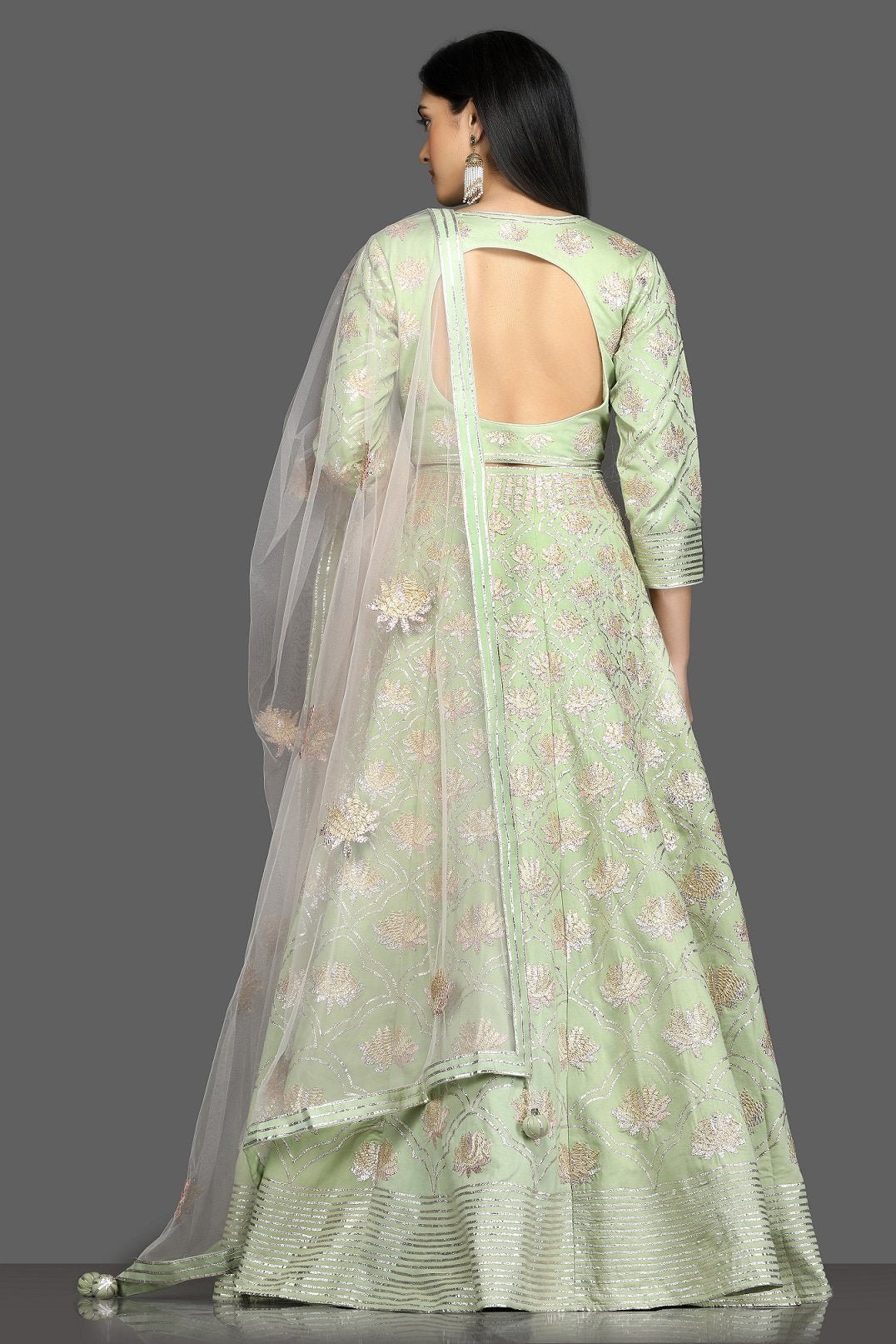 Shop pista green embroidered designer lehenga online in USA with net dupatta. Flaunt your sartorial choices on special occasions with beautiful designer gowns, Anarkali suits, traditional salwar suits, Indian lehengas from Pure Elegance Indian fashion boutique in USA. -back