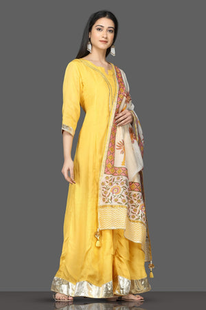 Buy beautiful yellow silk floorlength Anarkali suit online in USA with printed dupatta. Shop for parties and festive occasions stunning designer suits, Anarkali suits, designer gowns, wedding lehengas from Pure Elegance Indian fashion store in USA.-side