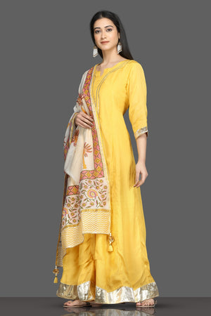 Buy beautiful yellow silk floorlength Anarkali suit online in USA with printed dupatta. Shop for parties and festive occasions stunning designer suits, Anarkali suits, designer gowns, wedding lehengas from Pure Elegance Indian fashion store in USA.-left