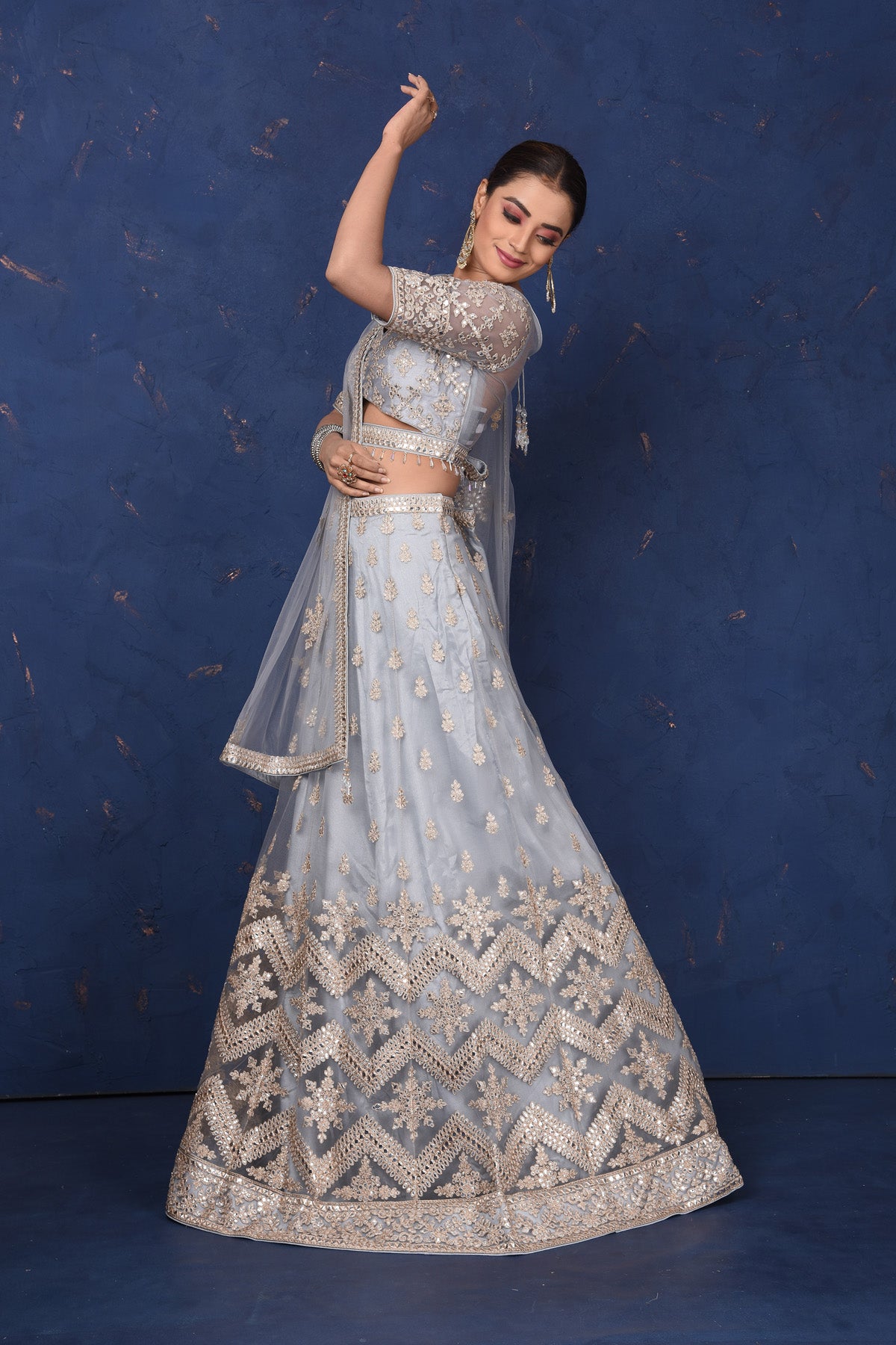 Buy beautiful light grey embroidered net lehenga online in USA with dupatta, Be the center of attraction on festive occasions in beautiful designer suits, dresses, lehengas, designer gowns, from Pure Elegance Indian fashion store in USA.-full view