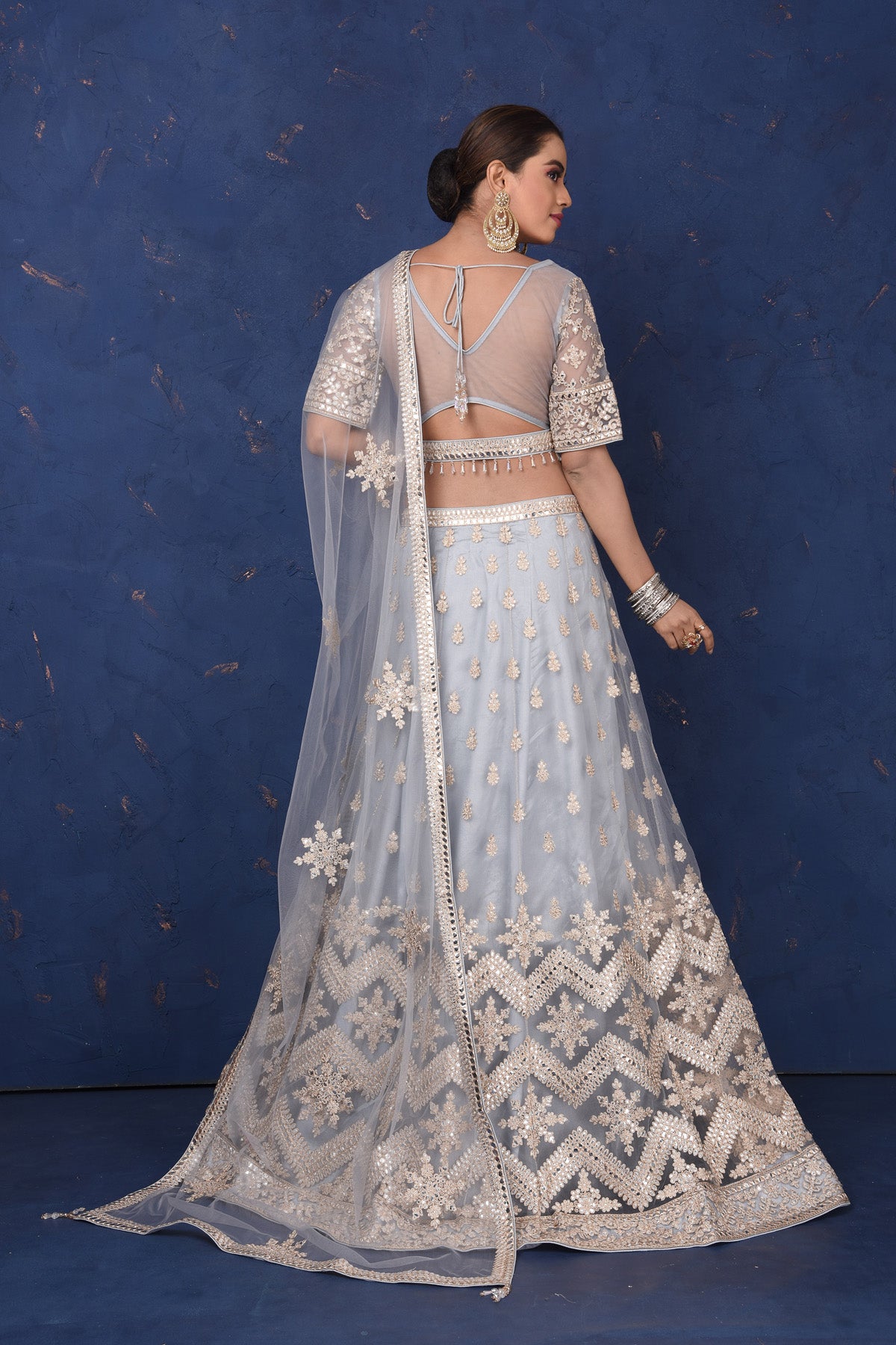 Buy beautiful light grey embroidered net lehenga online in USA with dupatta, Be the center of attraction on festive occasions in beautiful designer suits, dresses, lehengas, designer gowns, from Pure Elegance Indian fashion store in USA.-back