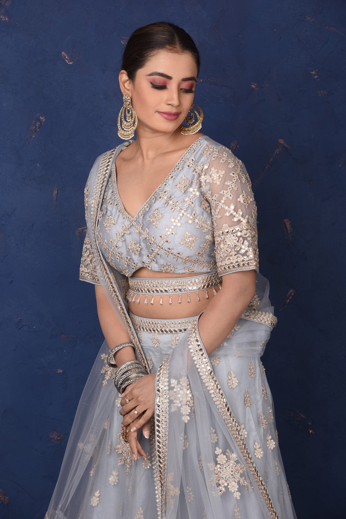 Buy beautiful light grey embroidered net lehenga online in USA with dupatta, Be the center of attraction on festive occasions in beautiful designer suits, dresses, lehengas, designer gowns, from Pure Elegance Indian fashion store in USA.-closeup