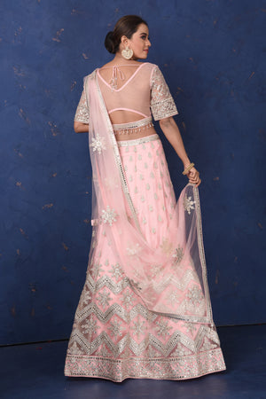Shop powder pink embroidered net lehenga online in USA with dupatta, Be the center of attraction on festive occasions in beautiful designer suits, dresses, lehengas, designer gowns, from Pure Elegance Indian fashion store in USA.-back