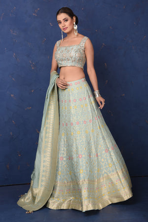 Shop beautiful mint green Banarasi embroidered lehenga online in USA with dupatta, Be the center of attraction on festive occasions in beautiful designer suits, dresses, lehengas, designer gowns, from Pure Elegance Indian fashion store in USA.-left
