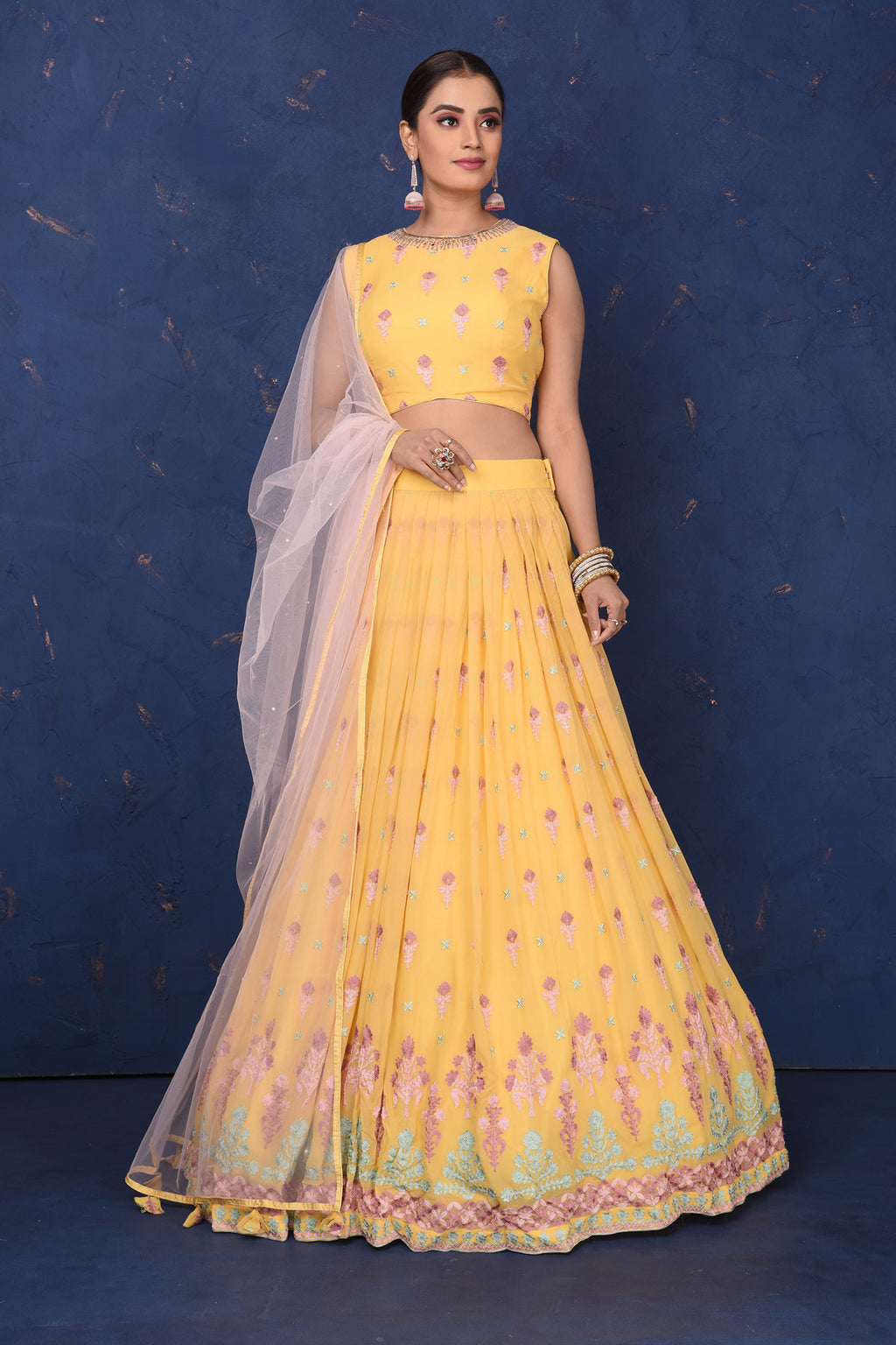Buy gorgeous yellow embroidered designer lehenga online in USA with pink dupatta, Be the center of attraction on festive occasions in beautiful designer suits, dresses, lehengas, designer gowns, from Pure Elegance Indian fashion store in USA.-full view