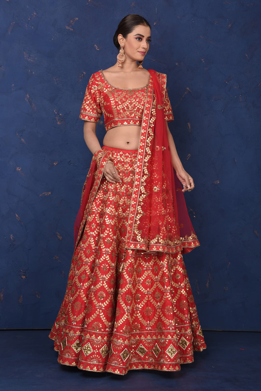 Buy stunning red embroidered designer lehenga online in USA with dupatta, Be the center of attraction on festive occasions in beautiful designer suits, dresses, lehengas, designer gowns, from Pure Elegance Indian fashion store in USA.-full view