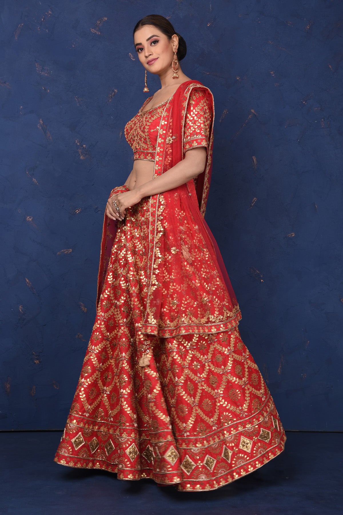 Buy stunning red embroidered designer lehenga online in USA with dupatta, Be the center of attraction on festive occasions in beautiful designer suits, dresses, lehengas, designer gowns, from Pure Elegance Indian fashion store in USA.-left