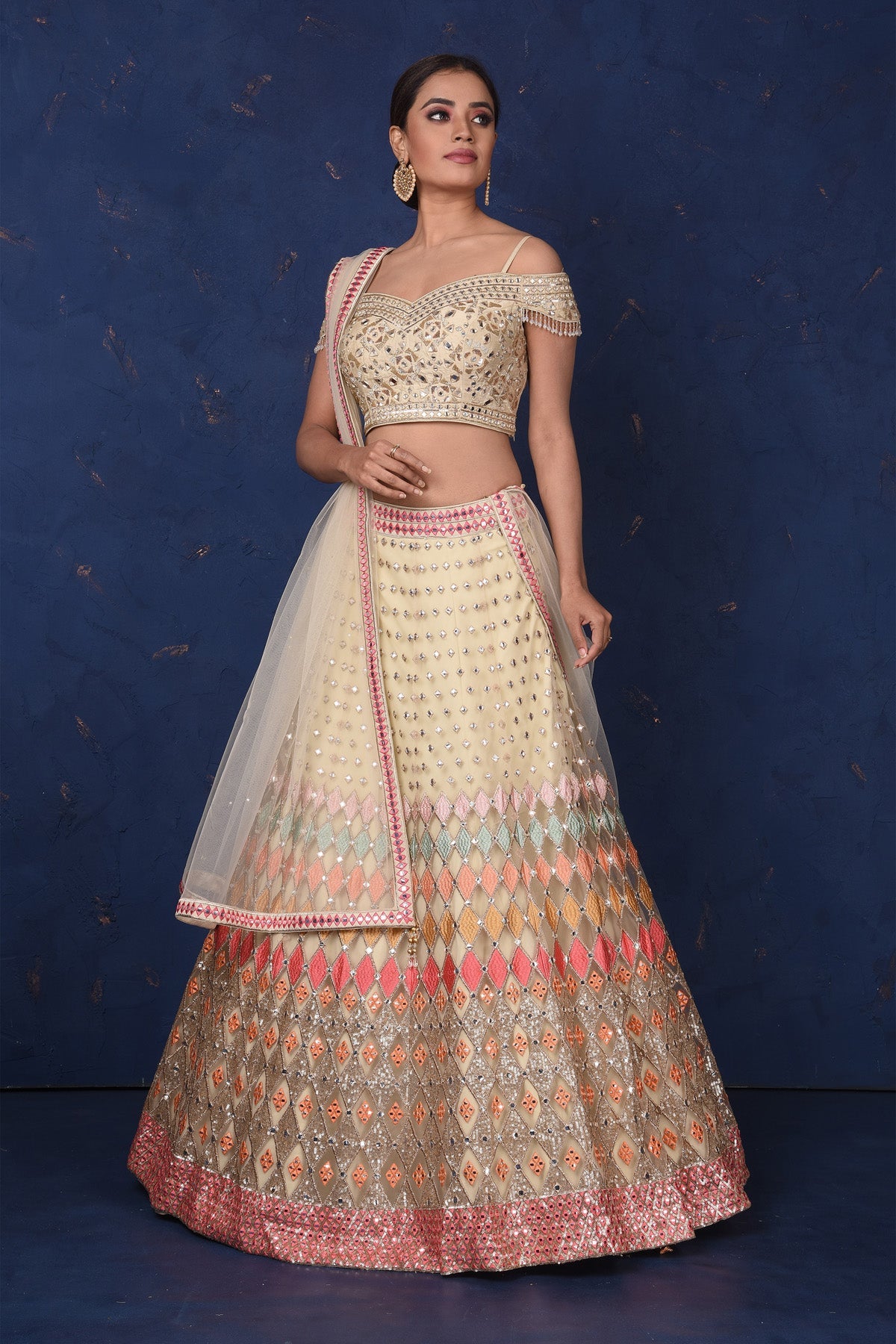 Buy stunning cream embroidered designer off-shoulder lehenga online in USA with dupatta. Set fashion goals on special occasions in exclusive designer lehengas, Indian suits, Anarkali dresses, designer gowns, bridal lehengas from Pure Elegance Indian fashion store in USA.-full view