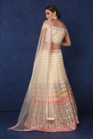 Buy stunning cream embroidered designer off-shoulder lehenga online in USA with dupatta. Set fashion goals on special occasions in exclusive designer lehengas, Indian suits, Anarkali dresses, designer gowns, bridal lehengas from Pure Elegance Indian fashion store in USA.-back