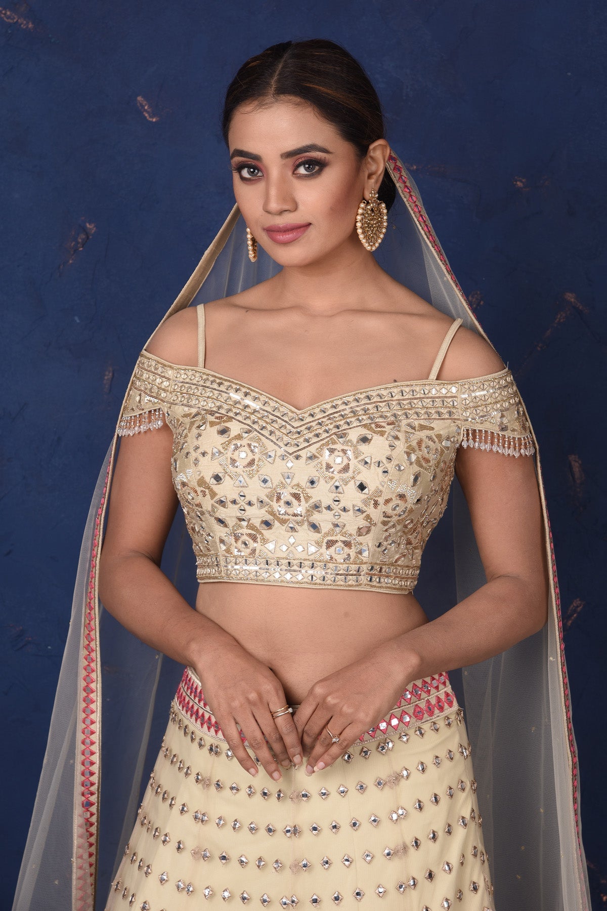 Buy stunning cream embroidered designer off-shoulder lehenga online in USA with dupatta. Set fashion goals on special occasions in exclusive designer lehengas, Indian suits, Anarkali dresses, designer gowns, bridal lehengas from Pure Elegance Indian fashion store in USA.-closeup