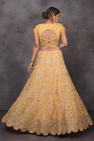 Buy beautiful mango yellow embroidered scalloped lehenga online in USA with dupatta. Look royal at weddings in this bespoke designer lehengas, wedding gowns, bridal lehengas, designer sarees, Anarkali suits, sharara suits, from Pure Elegance Indian fashion store in USA.-back