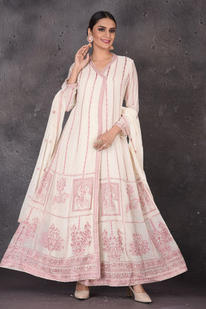 Buy gorgeous cream embroidered floorlength suit online in USA with dupatta. Look elegant at weddings and festive occasions in exclusive designer suits, designer gowns, Anarkali suits, sharara suits, bridal gowns, palazzo suits from Pure Elegance Indian clothing store in USA.-front