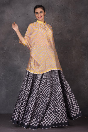 Buy stunning yellow and black Bandhej print skirt set online in USA. Look elegant at weddings and festive occasions in exclusive designer suits, designer gowns, Anarkali suits, sharara suits, bridal gowns, palazzo suits, designer lehenga from Pure Elegance Indian clothing store in USA.-side