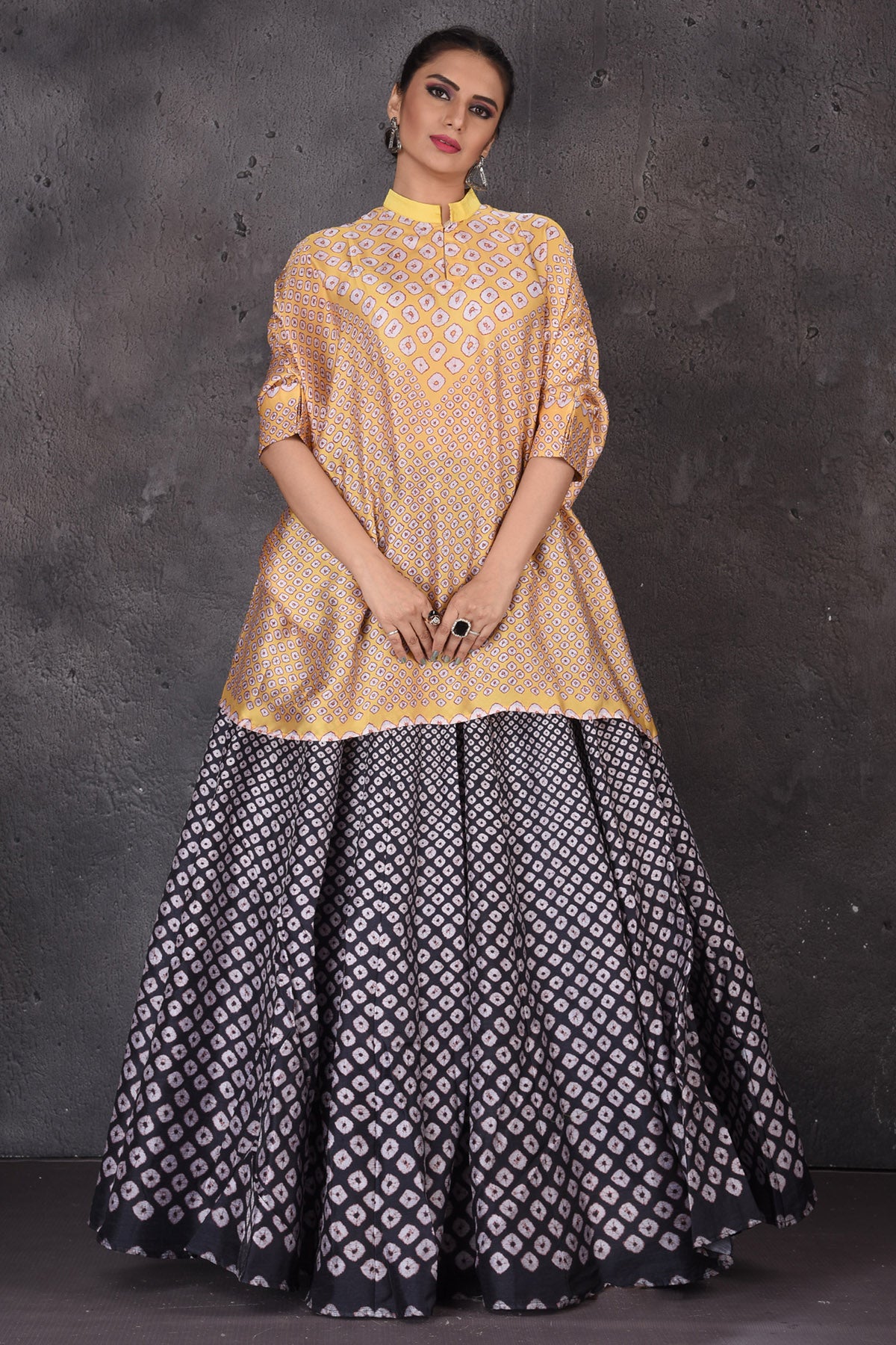 Buy stunning yellow and black Bandhej print skirt set online in USA. Look elegant at weddings and festive occasions in exclusive designer suits, designer gowns, Anarkali suits, sharara suits, bridal gowns, palazzo suits, designer lehenga from Pure Elegance Indian clothing store in USA.-front