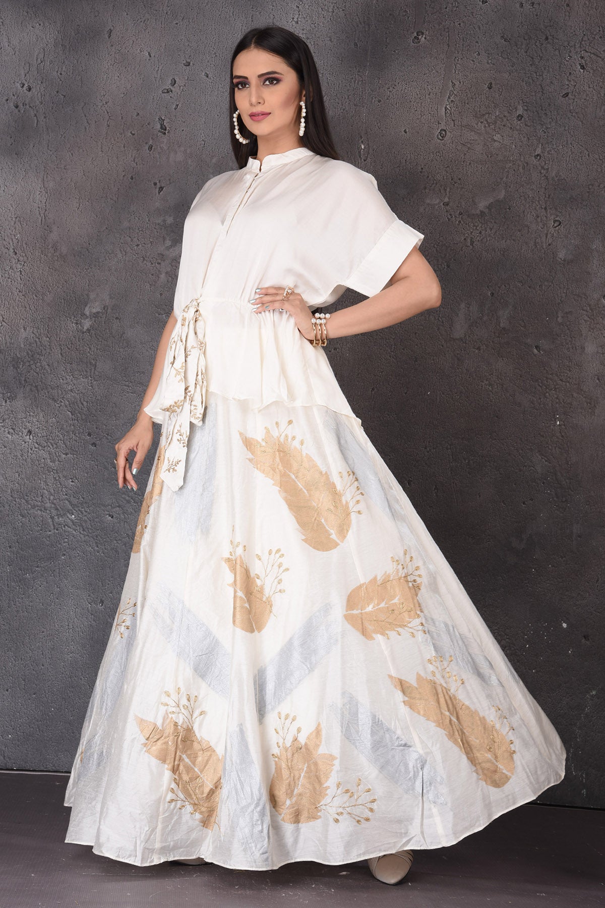 Shop stunning white skirt set online in USA with golden leaf print. Look elegant at weddings and festive occasions in exclusive designer suits, designer gowns, Anarkali suits, sharara suits, bridal gowns, palazzo suits, designer lehenga from Pure Elegance Indian clothing store in USA.-front