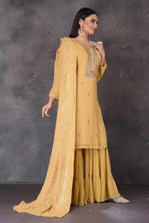 Buy beautiful yellow embroidered designer sharara suit online in USA with dupatta. Look elegant at weddings and festive occasions in exclusive designer suits, designer gowns, Anarkali suits, sharara suits, bridal gowns, palazzo suits, designer lehenga from Pure Elegance Indian clothing store in USA.-side