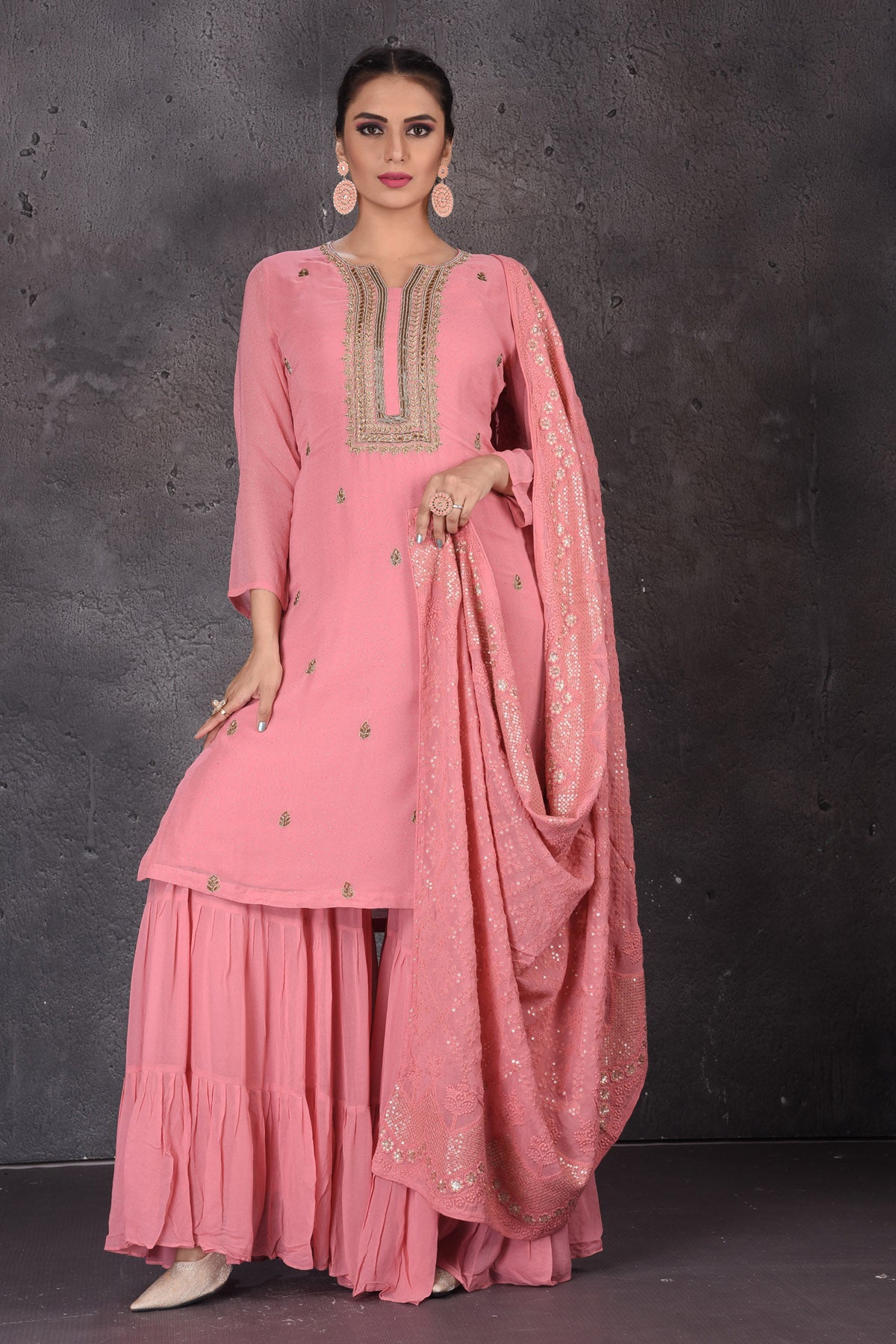 Shop stunning pink embroidered sharara suit online in USA with dupatta. Look elegant at weddings and festive occasions in exclusive designer suits, designer gowns, Anarkali suits, sharara suits, bridal gowns, palazzo suits, designer lehenga from Pure Elegance Indian clothing store in USA.-full view