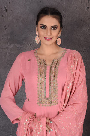 Shop stunning pink embroidered sharara suit online in USA with dupatta. Look elegant at weddings and festive occasions in exclusive designer suits, designer gowns, Anarkali suits, sharara suits, bridal gowns, palazzo suits, designer lehenga from Pure Elegance Indian clothing store in USA.-closeup