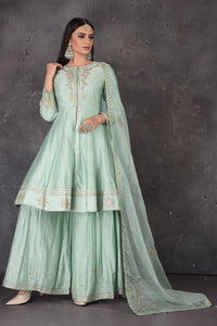 Shop beautiful mint green embroidered sharara suit online in USA with dupatta. Look elegant at weddings and festive occasions in exclusive designer suits, designer gowns, Anarkali suits, sharara suits, bridal gowns, palazzo suits, designer lehenga from Pure Elegance Indian clothing store in USA.-full view