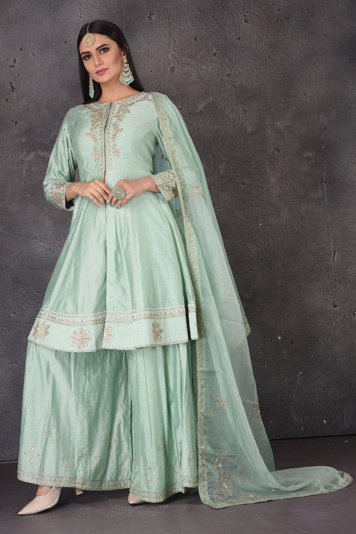 Shop beautiful mint green embroidered sharara suit online in USA with dupatta. Look elegant at weddings and festive occasions in exclusive designer suits, designer gowns, Anarkali suits, sharara suits, bridal gowns, palazzo suits, designer lehenga from Pure Elegance Indian clothing store in USA.-front