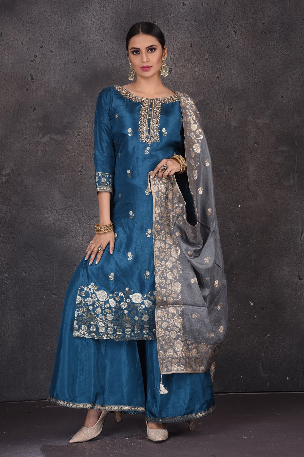 Buy stunning blue embroidered palazzo suit online in USA with grey dupatta. Look elegant at weddings and festive occasions in exclusive designer suits, designer gowns, Anarkali suits, sharara suits, bridal gowns, palazzo suits, designer lehenga from Pure Elegance Indian clothing store in USA.-full view