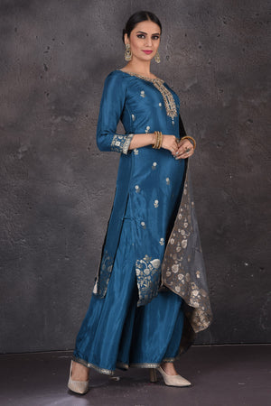 Buy stunning blue embroidered palazzo suit online in USA with grey dupatta. Look elegant at weddings and festive occasions in exclusive designer suits, designer gowns, Anarkali suits, sharara suits, bridal gowns, palazzo suits, designer lehenga from Pure Elegance Indian clothing store in USA.-side
