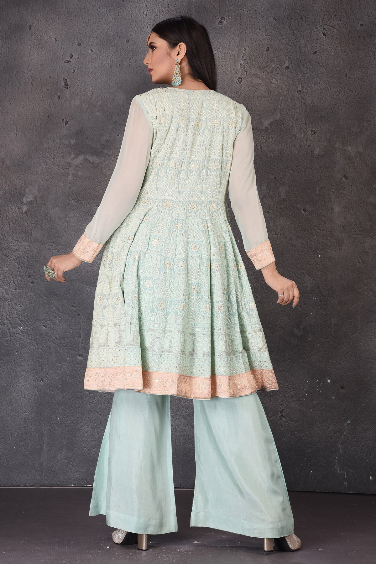 Buy gorgeous mint green embroidered sharara suit online in USA with pink dupatta. Look elegant at weddings and festive occasions in exclusive designer suits, designer gowns, Anarkali suits, sharara suits, bridal gowns, palazzo suits, designer lehenga from Pure Elegance Indian clothing store in USA.-back