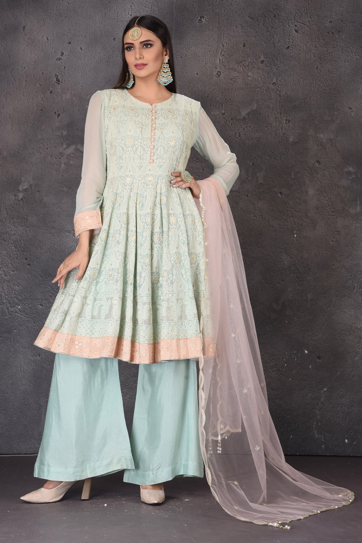 Buy gorgeous mint green embroidered sharara suit online in USA with pink dupatta. Look elegant at weddings and festive occasions in exclusive designer suits, designer gowns, Anarkali suits, sharara suits, bridal gowns, palazzo suits, designer lehenga from Pure Elegance Indian clothing store in USA.-full view