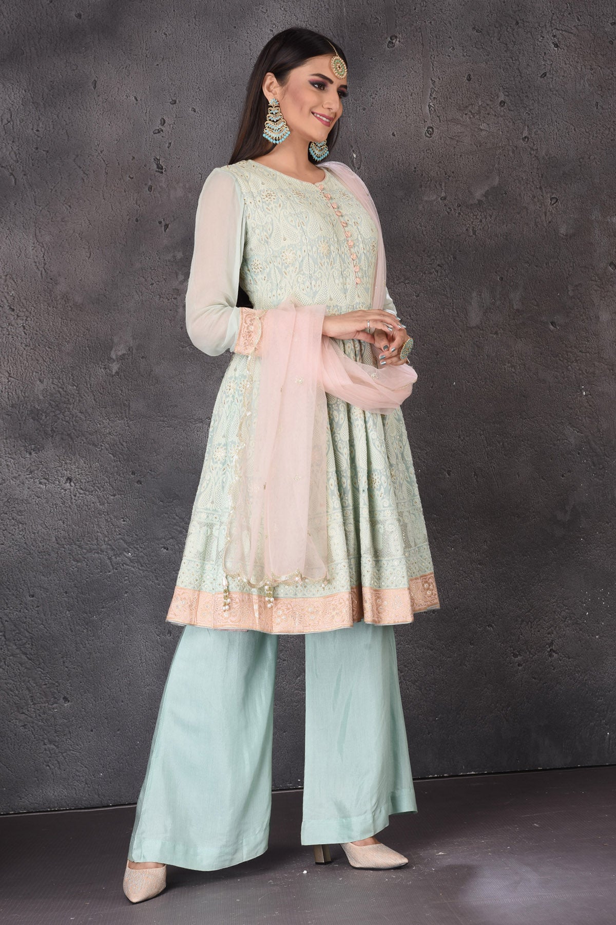 Buy gorgeous mint green embroidered sharara suit online in USA with pink dupatta. Look elegant at weddings and festive occasions in exclusive designer suits, designer gowns, Anarkali suits, sharara suits, bridal gowns, palazzo suits, designer lehenga from Pure Elegance Indian clothing store in USA.-right