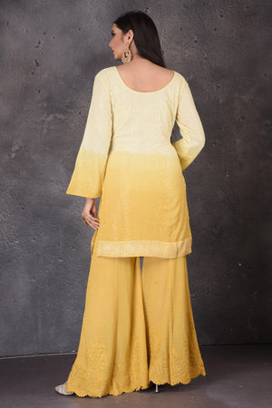 Buy stunning yellow embroidered sharara suit online in USA with dupatta. Look elegant at weddings and festive occasions in exclusive designer suits, designer gowns, Anarkali suits, sharara suits, bridal gowns, palazzo suits, designer lehenga from Pure Elegance Indian clothing store in USA.-back