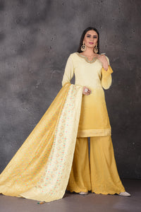 Buy stunning yellow embroidered sharara suit online in USA with dupatta. Look elegant at weddings and festive occasions in exclusive designer suits, designer gowns, Anarkali suits, sharara suits, bridal gowns, palazzo suits, designer lehenga from Pure Elegance Indian clothing store in USA.-full view