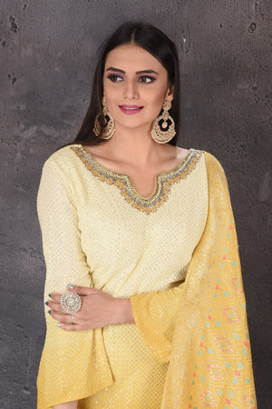 Buy stunning yellow embroidered sharara suit online in USA with dupatta. Look elegant at weddings and festive occasions in exclusive designer suits, designer gowns, Anarkali suits, sharara suits, bridal gowns, palazzo suits, designer lehenga from Pure Elegance Indian clothing store in USA.-closeup