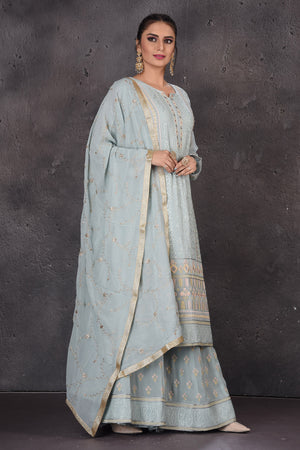 Buy gorgeous powder blue embroidered palazzo suit online in USA with dupatta. Look elegant at weddings and festive occasions in exclusive designer suits, designer gowns, Anarkali suits, sharara suits, bridal gowns, palazzo suits, designer lehenga from Pure Elegance Indian clothing store in USA.-side
