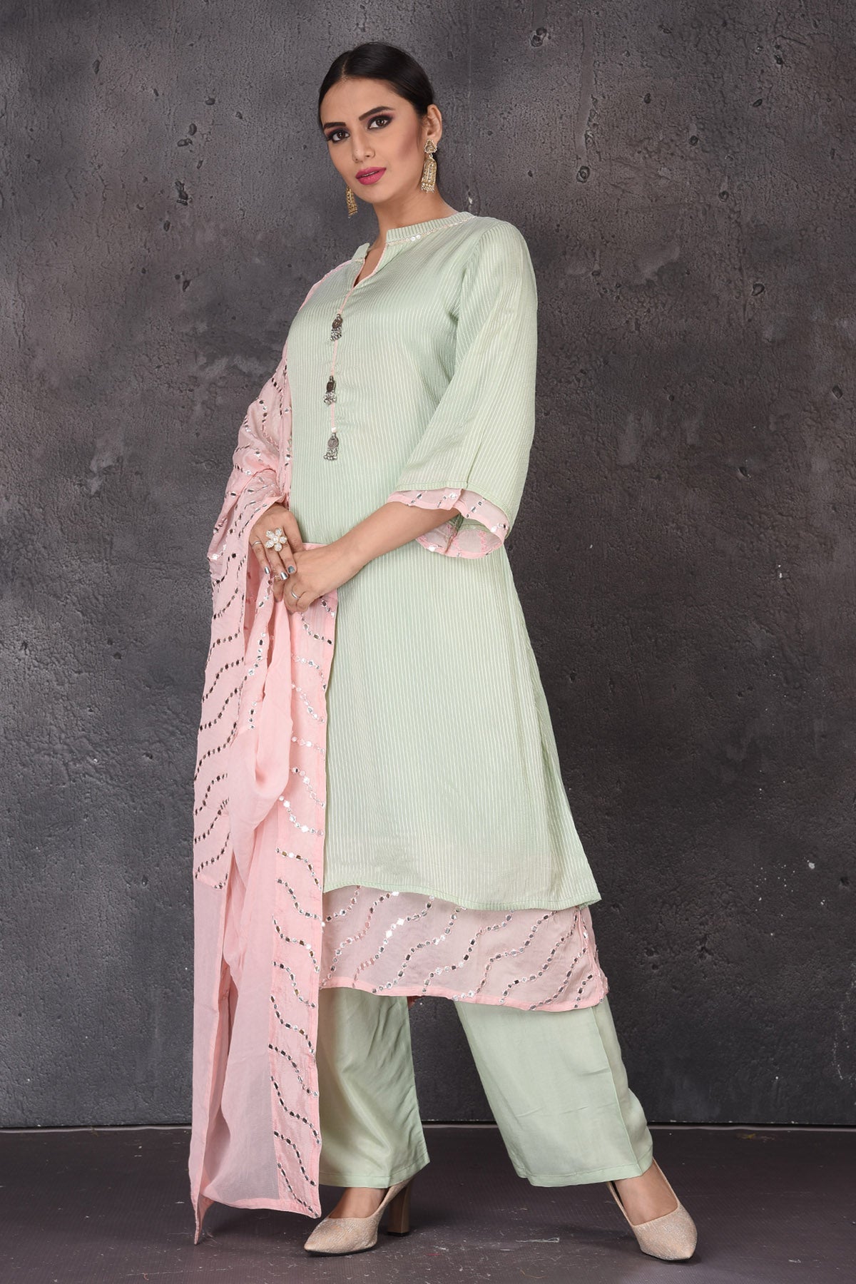 Buy beautiful mint green embroidered palazzo suit online in USA with pastel pink dupatta. Look elegant at weddings and festive occasions in exclusive designer suits, designer gowns, Anarkali suits, sharara suits, bridal gowns, palazzo suits, designer lehenga from Pure Elegance Indian clothing store in USA.-palazzo