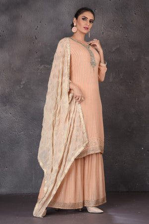 Buy beautiful peach embroidered palazzo suit online in USA with dupatta. Look elegant at weddings and festive occasions in exclusive designer suits, designer gowns, Anarkali suits, sharara suits, wedding gowns, palazzo suits, designer lehenga from Pure Elegance Indian clothing store in USA.-side