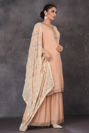 Buy beautiful peach embroidered palazzo suit online in USA with dupatta. Look elegant at weddings and festive occasions in exclusive designer suits, designer gowns, Anarkali suits, sharara suits, wedding gowns, palazzo suits, designer lehenga from Pure Elegance Indian clothing store in USA.-side