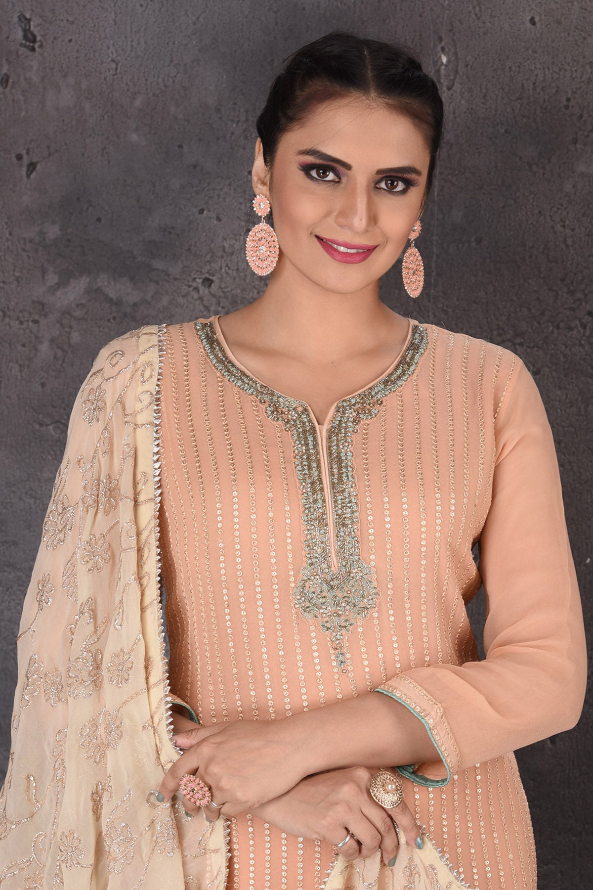 Buy beautiful peach embroidered palazzo suit online in USA with dupatta. Look elegant at weddings and festive occasions in exclusive designer suits, designer gowns, Anarkali suits, sharara suits, wedding gowns, palazzo suits, designer lehenga from Pure Elegance Indian clothing store in USA.-closeup
