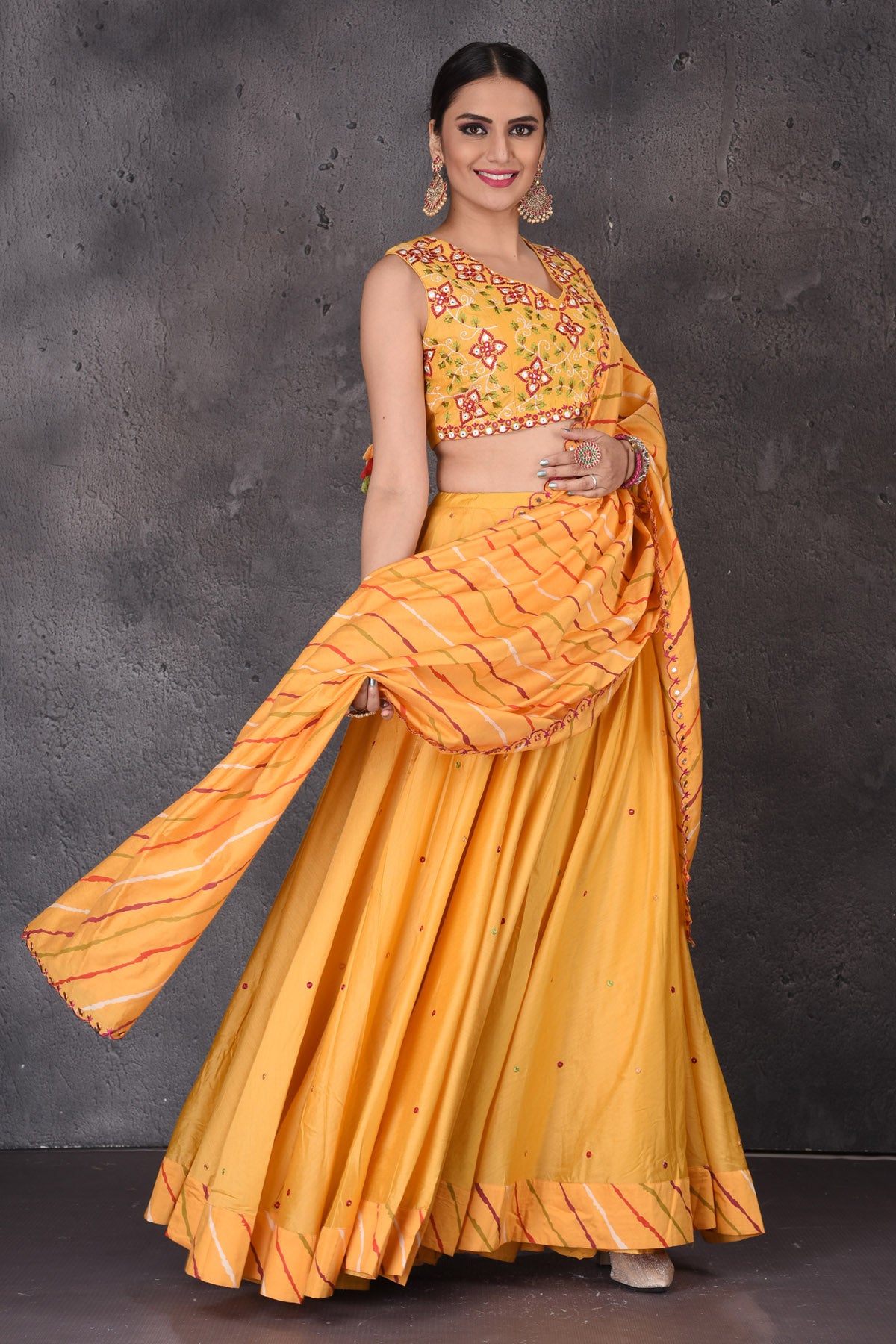 Buy stunning yellow embroidered designer lehenga online in USA with dupatta. Look elegant at weddings and festive occasions in exclusive designer suits, designer gowns, Anarkali suits, sharara suits, wedding gowns, palazzo suits, designer lehenga from Pure Elegance Indian clothing store in USA.-side