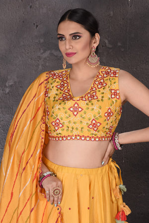 Buy stunning yellow embroidered designer lehenga online in USA with dupatta. Look elegant at weddings and festive occasions in exclusive designer suits, designer gowns, Anarkali suits, sharara suits, wedding gowns, palazzo suits, designer lehenga from Pure Elegance Indian clothing store in USA.-closeup